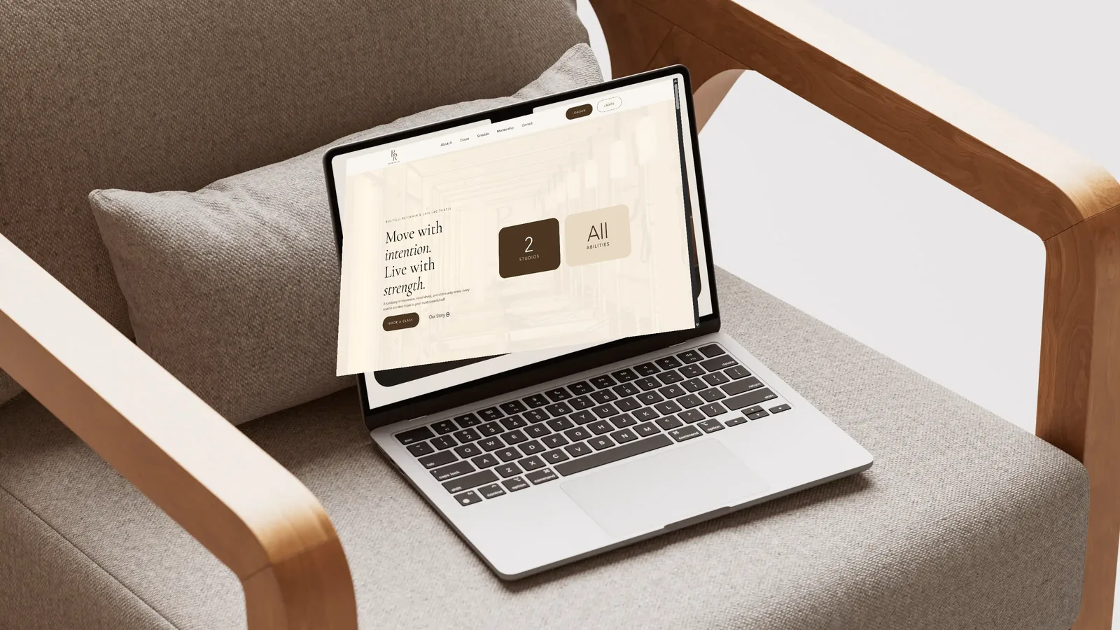 Laptop on an armchair showing the BR Reformer Studios website homepage