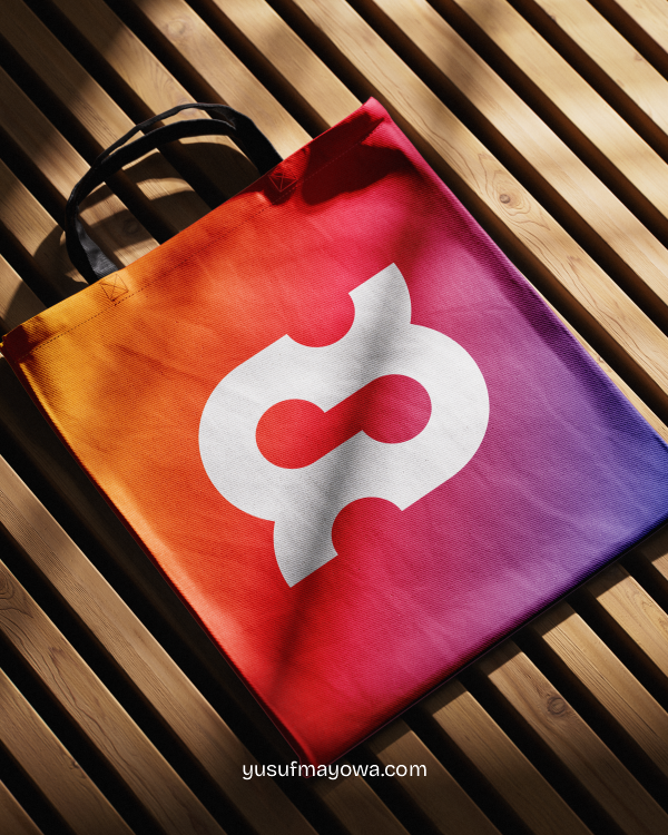 Tote bag with the colourful gradient Revion logo mark in warm light